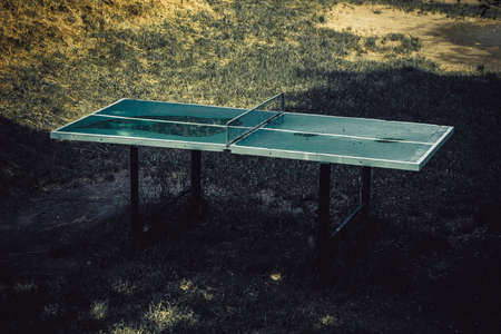 Outdoors abandoned ping pong table, toned image