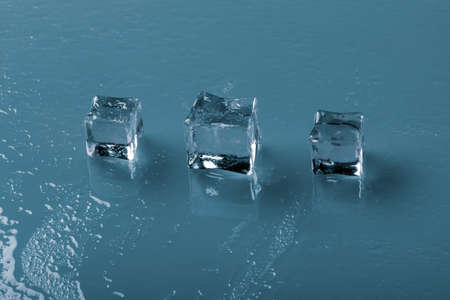 Set of crystal clear ice cubes over blue background