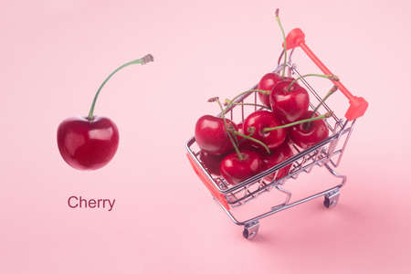 Creative layout made of red cherry, over pink background, creative minimalismの写真素材
