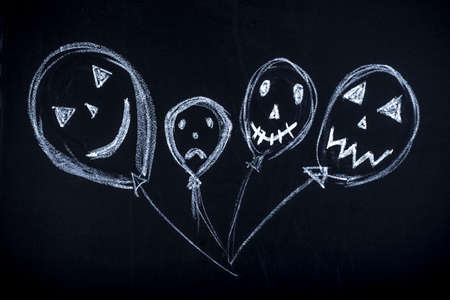 balls drawn in chalk with funny snouts, concept for Halloween
