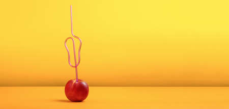 cocktail straw in peach on orange background, concept of juicy peach, panoramic imageの写真素材