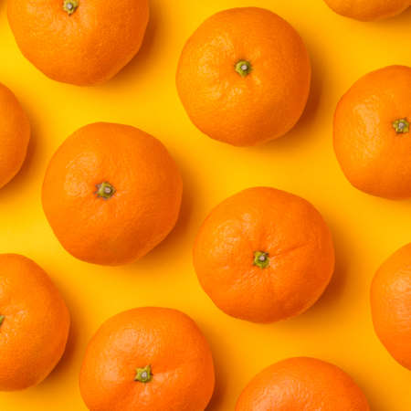 Fruit pattern of mandarin on yellow background. Tangerine. Flat lay, top view.の写真素材