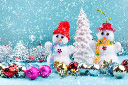 Christmas card with a Christmas tree, balls and snowmenの写真素材