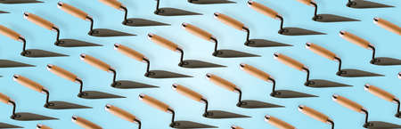 Triangle trowel (building spatula) pattern over blue  backgroundの写真素材