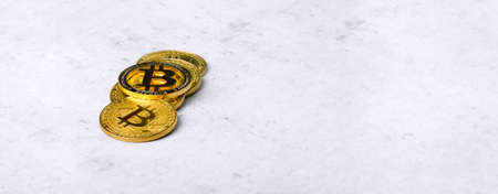 golden bitcoins on a concrete background, panoramic mock-up with space for textの写真素材