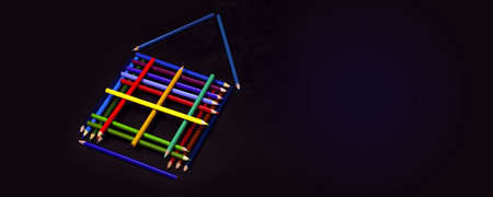 colored pencils laid out in the shape of a house on dark background, panoramic mock-up with space...