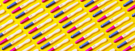 panoramic pattern with positive pregnancy tests over yellow backgroundの写真素材