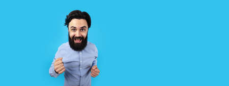 caucasian funny man is feeling happy on blue background, panoramic mock-up