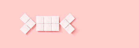 candy made of white cubes of sugar on a pink backgroundの写真素材