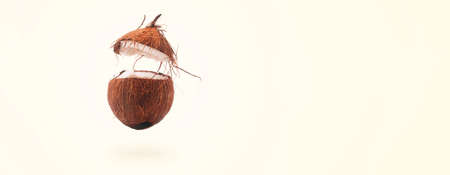opened coconut levitating over yellow background, summer food conceptの写真素材