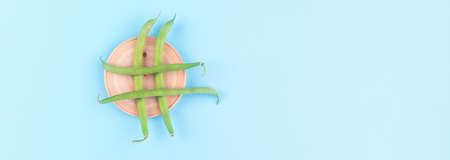 Hashtag from green beans over blue background