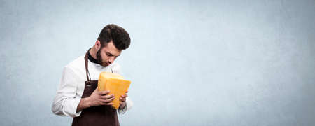 the chef looks thoughtfully at the cheese