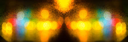 Colorful defocused bokeh lights background. City glare abstract background.