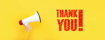 megaphone in hand and inscription thank you on a yellow background, concept of thanks for attention, panoramic imageの写真素材