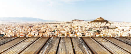 empty wooden table on city background, panoramic imageの写真素材