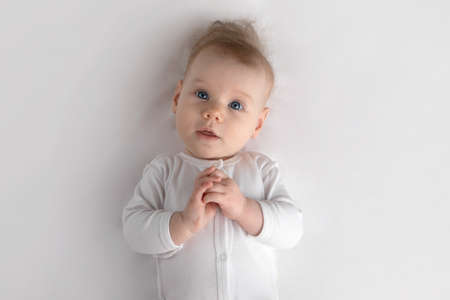 small baby in white clothes