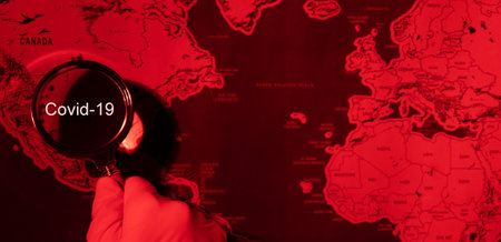 Covid-19 is outbreak while search people with infection with magnifying glass on world map, coronavirus disease with pandemic in global, detected and protection epidemic, diagnosis and research.の写真素材