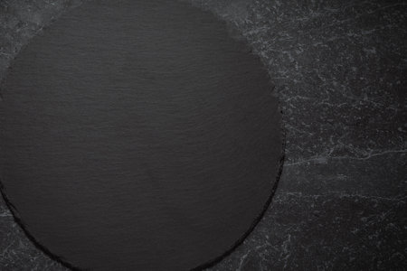 Slate plate on table. black slate stone on marble background. copy spaceの写真素材