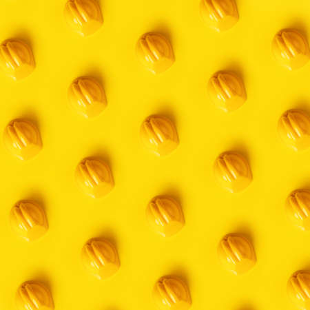 hard hat pattern over yellow backgroundの写真素材