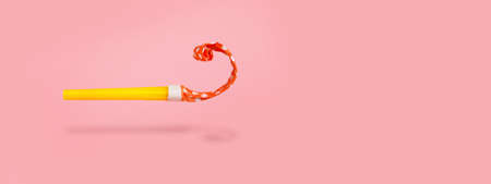 levitating whistle over pink background, birthday celebration and party concept, panoramic mock-upの写真素材