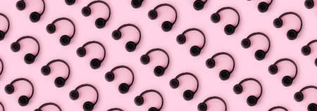 headphones pattern over pink background, music and sound concept, panoramic imageの写真素材