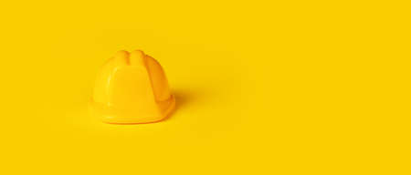 children's yellow helmet, construction concept, minimalistic photo, panoramic mock-up