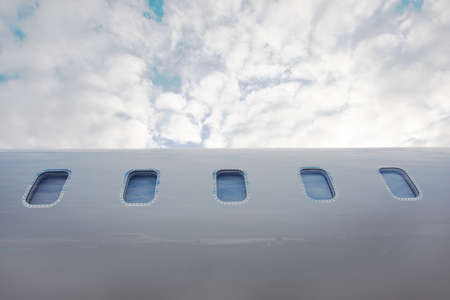 an airplane illuminators of private business jet over sky background
