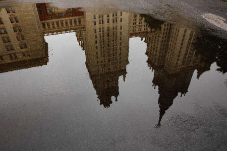 Moscow, Russia september 11. 2021 Reflection of the main building of Moscow State University in a puddle, autumn architecture after rainの写真素材