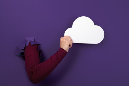Cloud computing concept, hand holding cloud over purple background, cloud storageの写真素材