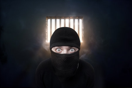 criminal in balaclava in prison, 3d renderの写真素材