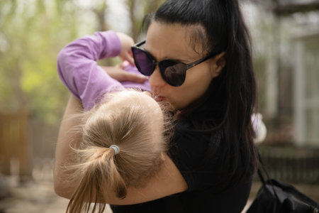 little girl in the arms of her mother
