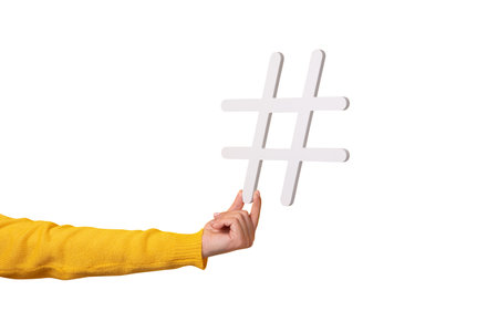 hand holding hashtag symbol, making important topic popular, setting trends on Internet.の写真素材