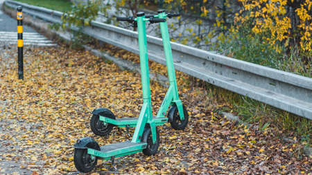 View of some green Electric Scooters parked on the sidewalk in Bratislava. This E-scooters used for...
