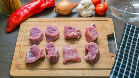 Top view of raw Pork tenderloin and vegetables on cutting board, Fresh raw meat prepared for cookingの写真素材