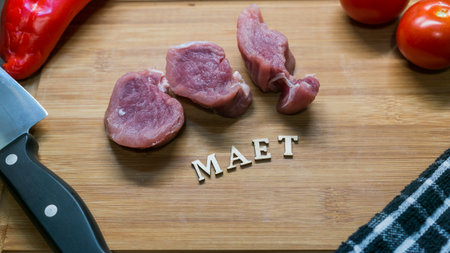 Top view of raw Pork tenderloin and vegetables on cutting board, Fresh raw meat prepared for cookingの写真素材
