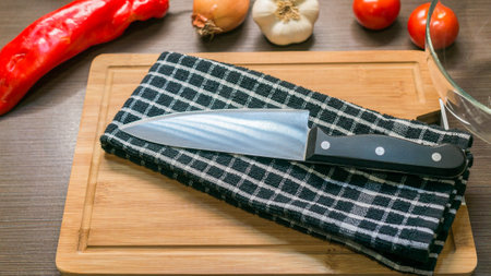 big kitchen Knife on cutting board with vegetablesの写真素材