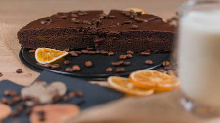 slices of chocolate brownie cake with cap milk and coffee beanas on wooden tableの写真素材