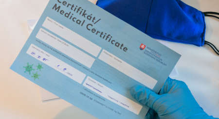 Bratislava, Slovak Republic - 09.02.2021: laboratory assistant analyzes negative PCR certificate of...