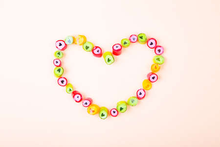 Vivid color heart shaped sugar candy on light background. Flat Lay composition.の写真素材