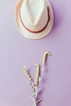 Flat lay style composition of lemongrass flower and straw hat.の写真素材
