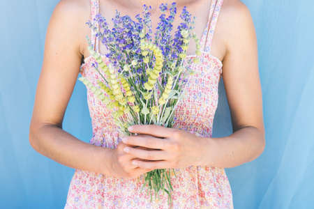 Portrait of beautiful smiling dark hair woman with lemon grass and lavander herbs in her hair. Natural beauty consept.の写真素材