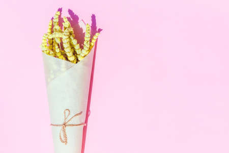 Flat lay style composition of lemongrass herbs  flower wrapped into craft paper on colorful ...