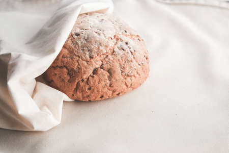 Fresh homemade backed brown bread with seeds and cereals on linen background.の写真素材