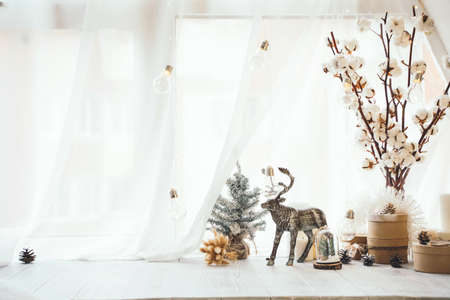 New year composition made of christmas balls. trees, deer, and many different knick knacks on a wooden background.の写真素材