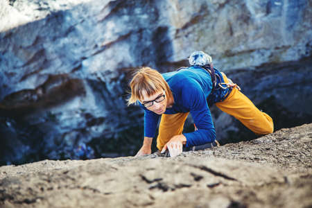 Athletic man climbs very high tufa rock with rope in Turkey. Sport climbing, lead.の写真素材