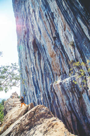 Athletic man looking at pitch on the big wall rock in Turkey. Sport climbing, lead.の写真素材