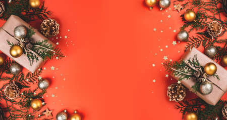 New year composition made of christmas balls, cones, pine branches on pink background. Flat lay style.の写真素材