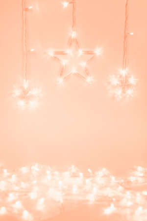 Star shaped garland lights on soft pink background. Festive project backdrop.の写真素材