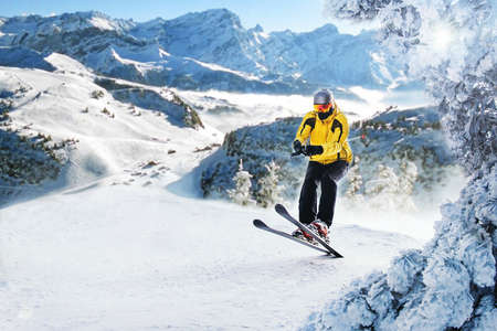 Mountain skier in Alp mountains doing some ski  jumping. Ski mountain sport.の写真素材