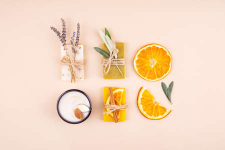 Organic natural set made of olive, lavender and orange pieces of soap, almond oil cream and dried herbs. Organic spa set.の写真素材